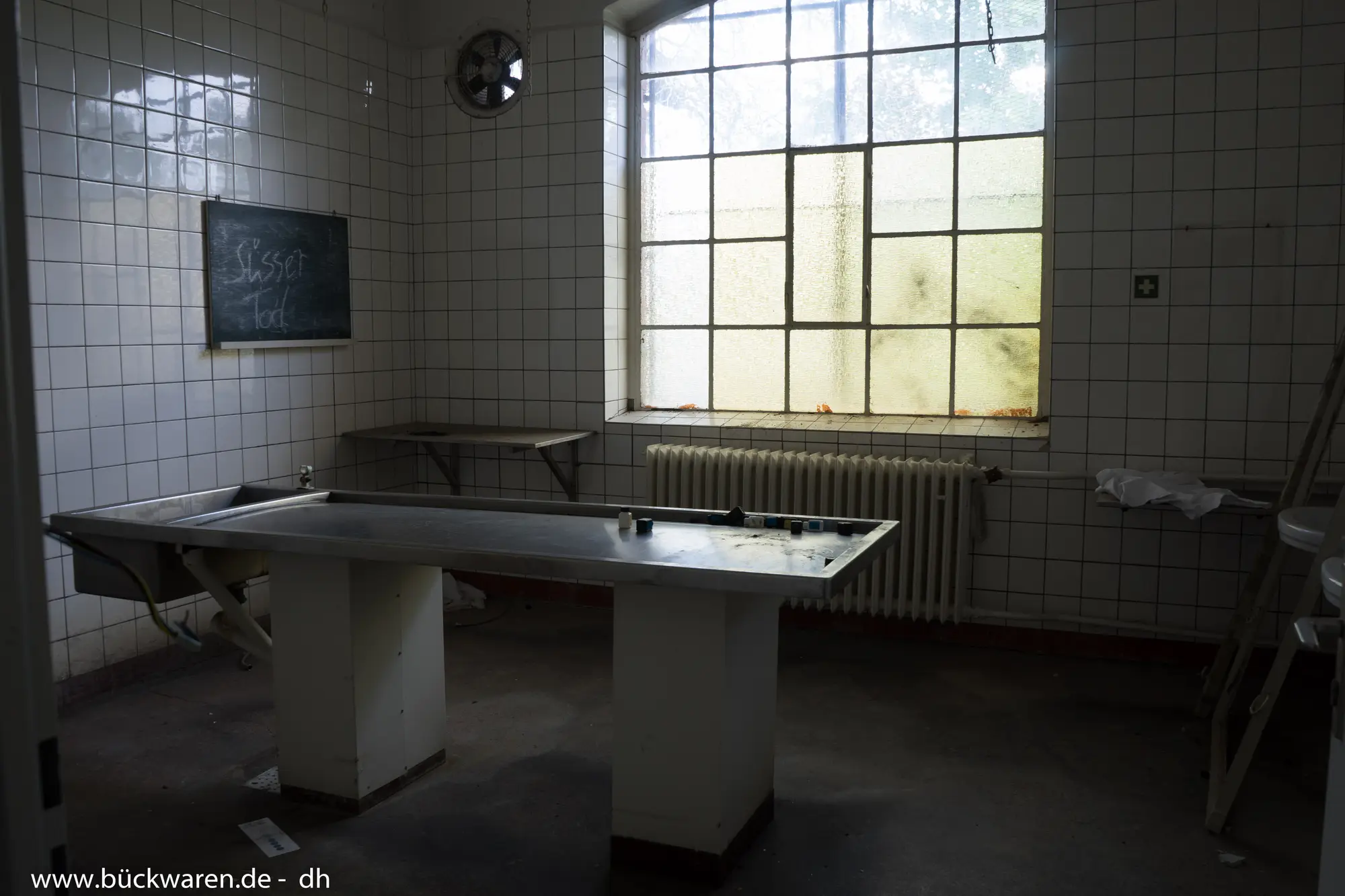 Der Tisch aus Edelstahl. An der Tafel steht etwas, das wir nicht geschrieben haben.